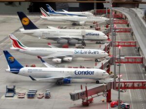 Detailed miniature model of an airport terminal with various aircraft brands on display.